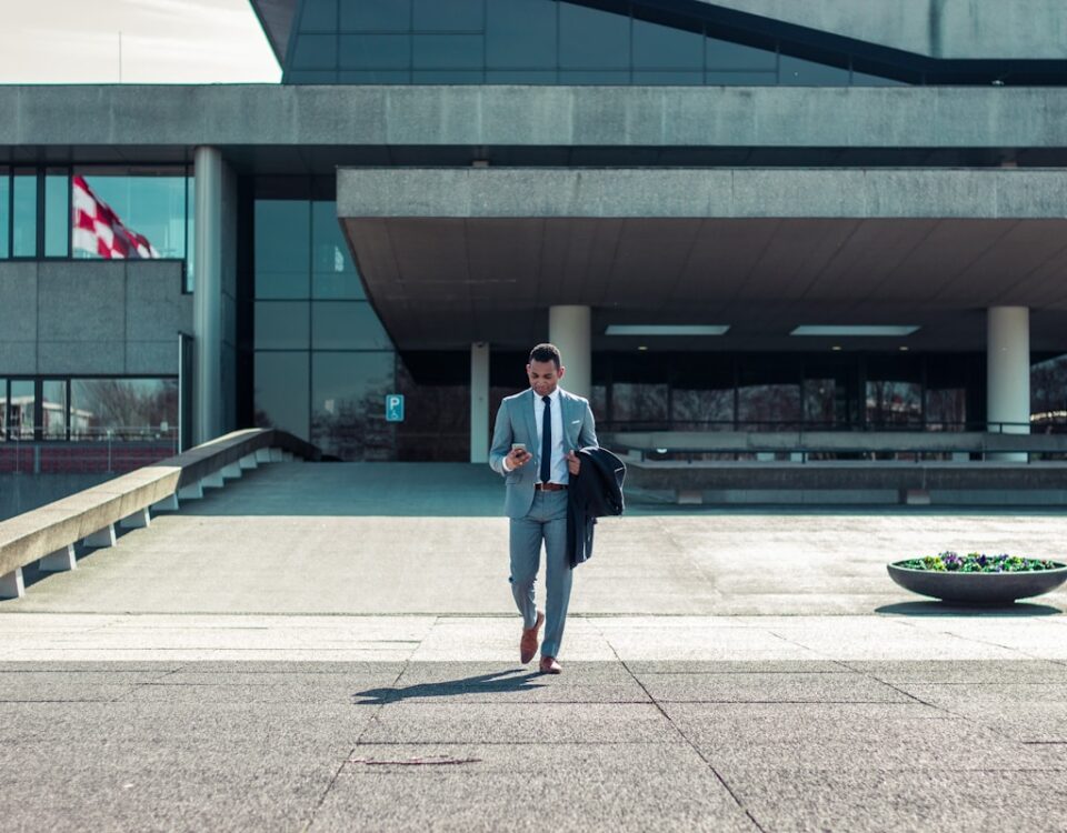 Quais Aspectos Legais Todo Empreendedor Precisa Conhecer? man walking while holding black coat