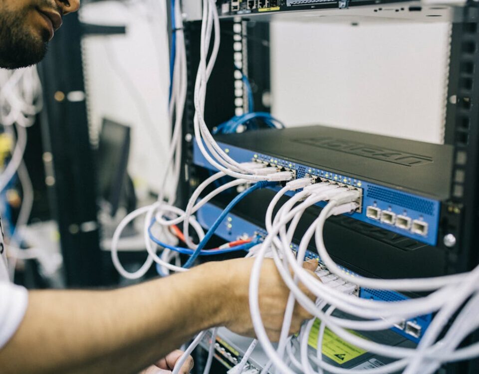 Electronics Engineer Fixing Cables on Server