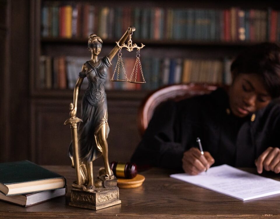 A Figurine of the Lady Justice on the Table of a Judge