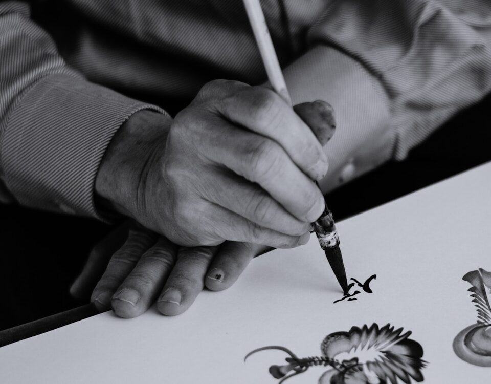 Arteterapia e direitos autorais: como proteger suas criações gray scale photo of person holding ink pen