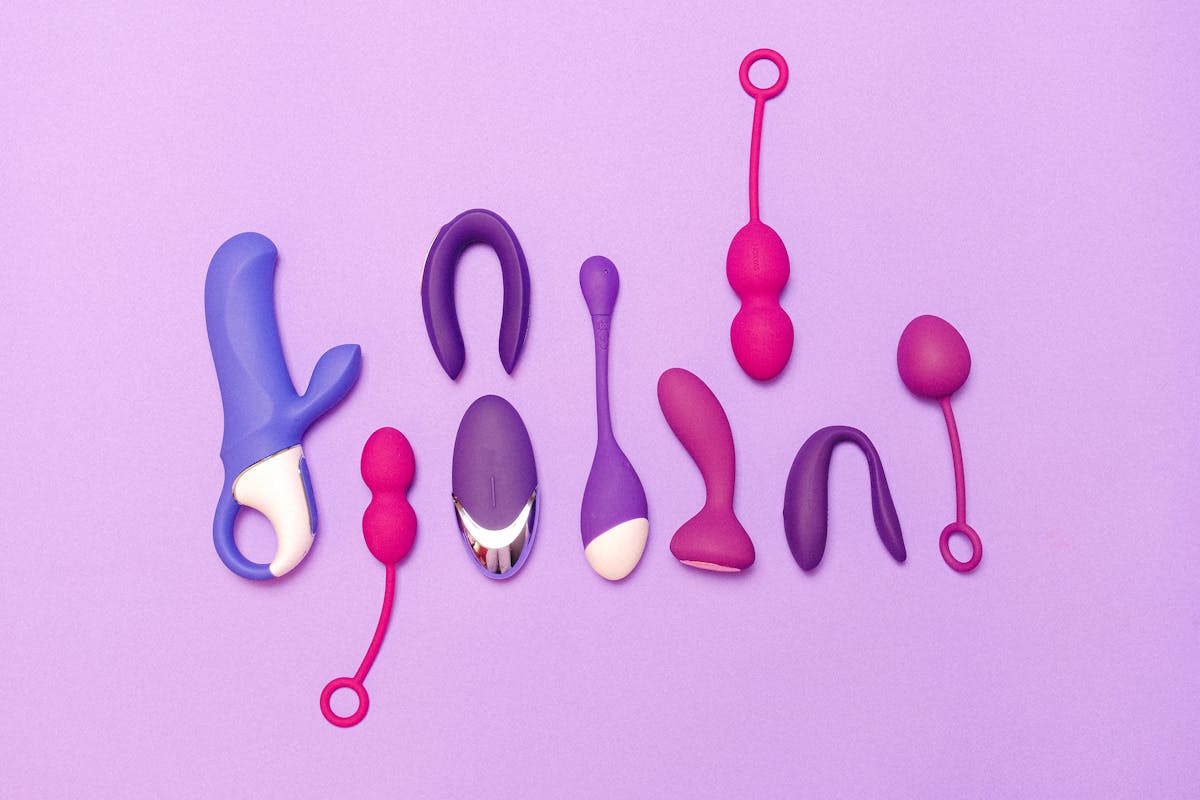 Various silicone sex toys displayed on a purple background for pleasure and education.