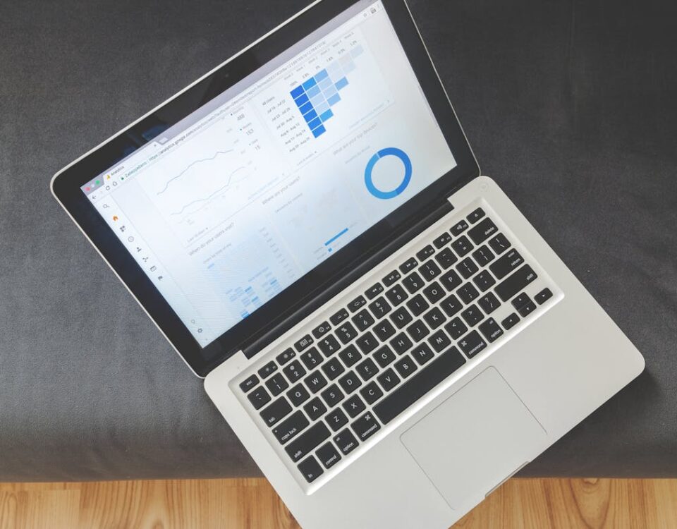 Painéis SMM e a legalidade no uso de automações Overhead view of a laptop showing data visualizations and charts on its screen.