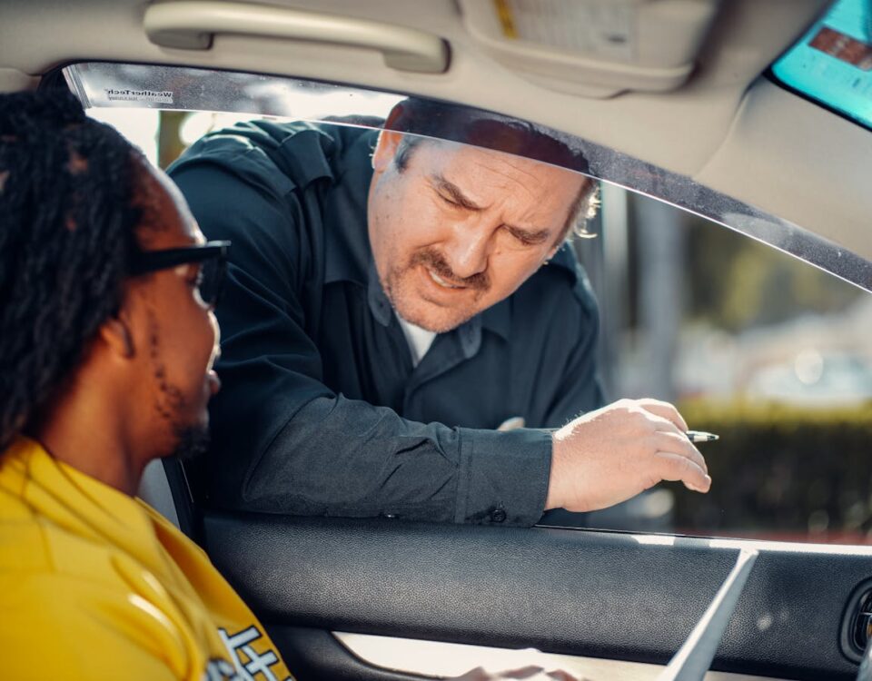 CNH suspensa: Quais são os seus direitos? A police officer interacts with a driver through a car window, emphasizing law enforcement and public safety.