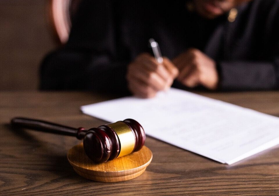 Juiz assinando documentos na mesa